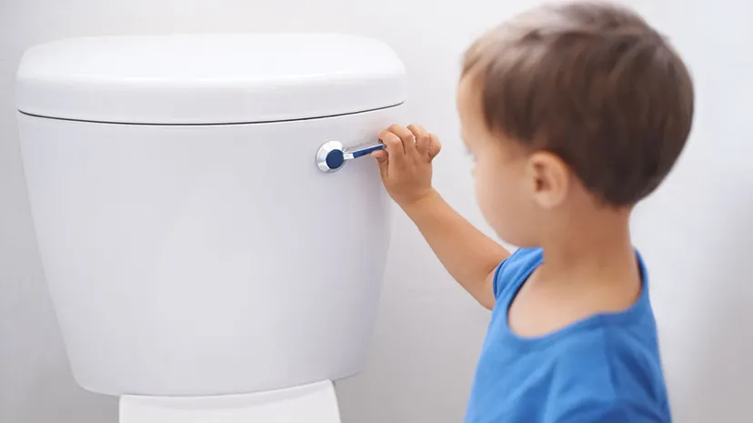 A boy is flushing 
